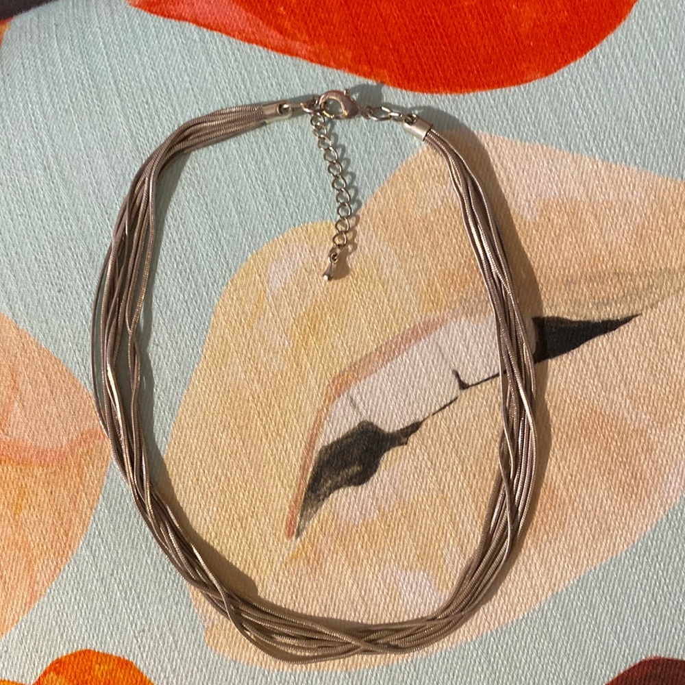 Silver multi strand necklace.